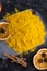 Curcuma turmeric spice with dry oranged served at black table. Food and cuisine ingredients. healthy concept. close up. flat lay