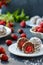 Curd balls with coconut shavings, strawberries and chocolate chip cookies located on a dark background, vertical