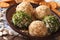 Curd cheese balls with crackers, herbs and pumpkin seeds macro.