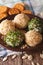 Curd cheese balls with crackers, herbs and pumpkin seeds macro.