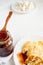 Curd pancakes, plum jam in glass jar and fresh curd on wooden table. Selective focus. Diagonal composition.