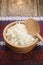 Curds in a wooden bowl