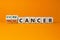 Cure or treat cancer symbol. Turned a cube and changes words `treat cancer` to `cure cancer`. Beautiful orange background. Med