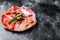 Cured meat platter of traditional Spanish tapas. Chorizo, jamon serrano, lomo and fuet. Black background. Top view. Copy space