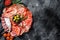 Cured meat platter of traditional Spanish tapas. Chorizo, jamon serrano, lomo and fuet. Black background. Top view. Copy space