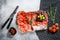 Cured meat platter of traditional Spanish tapas. Chorizo, jamon serrano, lomo and fuet. Gray background. Top view