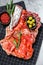 Cured meat platter of traditional Spanish tapas. Chorizo, jamon serrano, lomo and fuet. Gray background. Top view