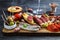 Cured meat platter of traditional Spanish tapas - chorizo, salsichon, jamon serrano, lomo - erved on wooden board with