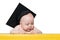 Curious baby in academic hat at the table. Educational concept. Isolate