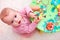 Curious baby girl playing with developing wooden toy