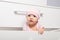 Curious baby looking out of the chest of drawers