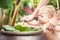 Curious baby with mother exploring flora in tropical garden during summer holidays