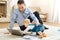 Curious baby touching the laptop while crawling on the carpet