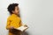 Curious black child boy reading a book on white background