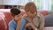 Curious boy having conversation with senior woman. Thoughtful boy waving head