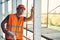 Curious builder touching the incomplete construction and holding drawings