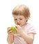 Curious child examining green apple
