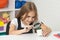 curious child looking at plant through magnifying glass, curiosity