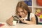 curious child looking at plant through magnifying glass, curiosity