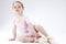 Curious and Cute Little Girl Posing as Ballerina in Toes. Against White Background