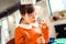 Curious dark-haired girl smelling liquid for soapy bubbles