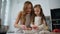 Curious daughter decorating cake with mom kitchen closeup. Woman teach kid bake