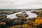 curious forms of nature forming round islands with trees in a small lake crossed by a quiet and lonely narrow road under