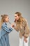 Curious good-looking ladies in funky shirts tasting each other sweets