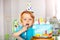 Curious happy two y.o. toddler with birthday cake