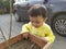 Curious Indian Toddler checking flower pot