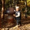 Curious kid playing with giant wooden mushroom