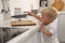 Curious little boy taking sharp knife from kitchen counter