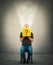 Curious man sitting on a chair looking cautious inside a mysterious yellow box as a magic light comes out