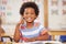 A curious mind builds a strong character. a preschool student showing thumbs up while sitting in class.