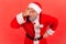 Curious nosy man in santa claus costume pretending to close eyes with hand attentively peeping through fingers, spying