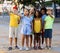 Curious preteen children pointing at something while walking outdoors