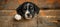 Curious puppy peeking over beige wooden surface, on blurred background with copy space