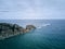 curious rocks in the sea with the waves crashing against them on a day with a cloudy sky, cabo de penas, spain