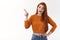Curious silly glamour redhead female modern urban stylish girl wear cropped sweater show belly look pointing upper left