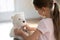 Curious small preschooler playing nurse patient with toy.