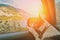 Curious traveling puppy dog in the car looking at the alps mountains sunset over austrian alps lake. Family vacation concept.