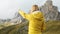 Curious woman point finger to mountain in Passo Giau pass