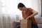 Curious woman unpacking cardboard box getting order from online store