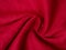 Curled red linen fabric texture, crimson color, copy space