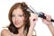 Curling female brunette hair with roller