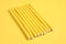 Curling rods on yellow background. Hair styling tool