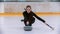 Curling training - a young woman with long hair on the ice rink holding a granite stone