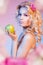 Curly blond woman with green apple