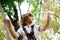 A curly child in climbing safety