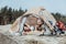 Curly dark-haired female hiker yawning while feeling very sleepy lying in tent